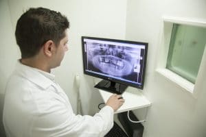 Dentist looking at x-ray